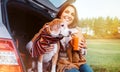 Woman with dog sit together in cat truck and warms Ãâ ÃËÃÂµÃâ¬ hot tea. Auto travel with pets concept image Royalty Free Stock Photo